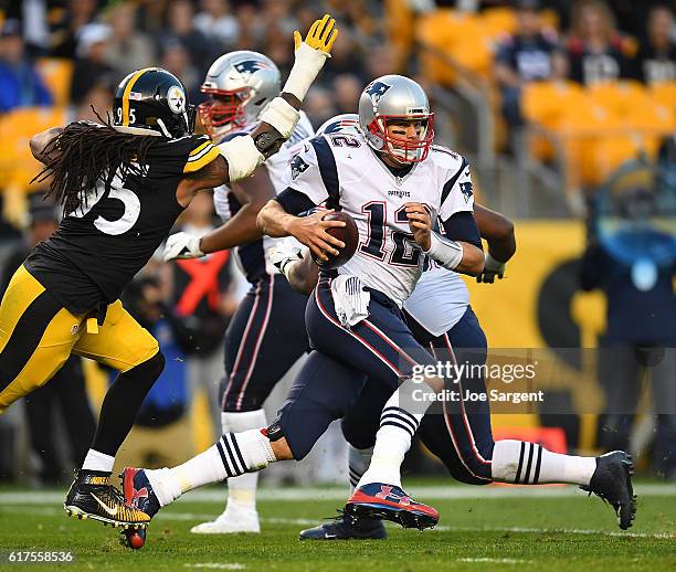 Tom Brady of the New England Patriots scrambles to avoid the rush of Jarvis Jones of the Pittsburgh Steelers in the second half during the game at...