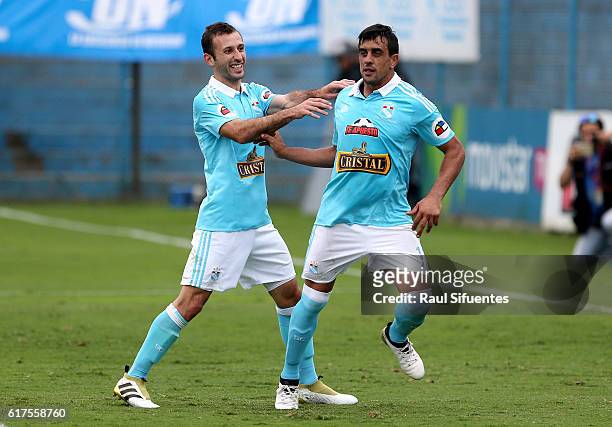 Diego Ifran of Sporting Cristal celebrates with teammate after scoring the third goal of his team during a match between Sporting Cristal and Cesar...