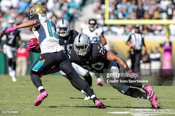 Oakland Raiders Safety Nate Allen attempts to tackle Jacksonville Jaguars Wide Receiver Rashad Greene during the NFL game between the Oakland Raiders...