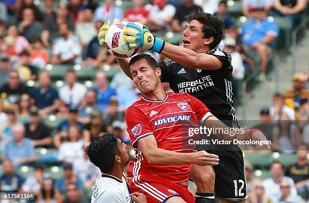 Goalkeeper Brian Rowe of the Los Angeles Galaxy makes a save as Matt Hedges of FC Dallas tries to get a head on the cross while A. J. DeLaGarza of...