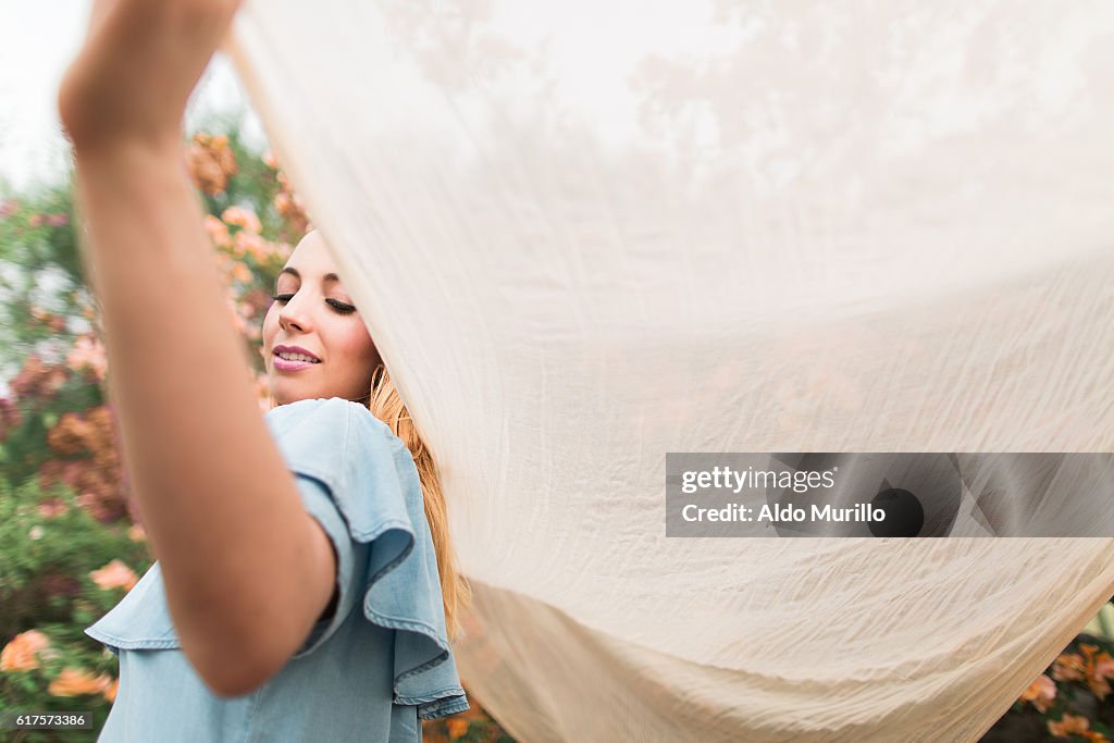 Latin woman holding a shawl and smiling