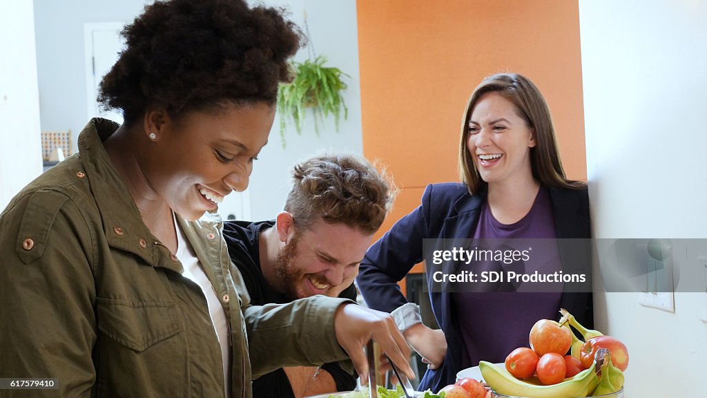 Young adults enjoy preparing meal together