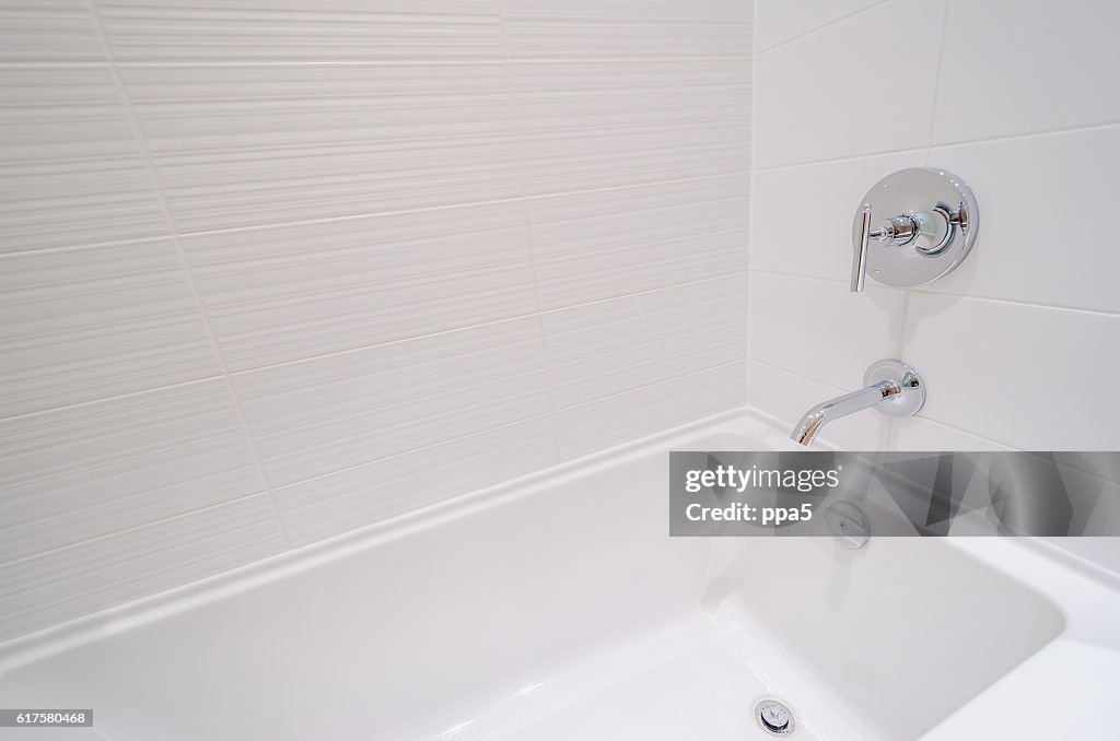 Fragment of a luxury bathroom with a detail of bathtub.