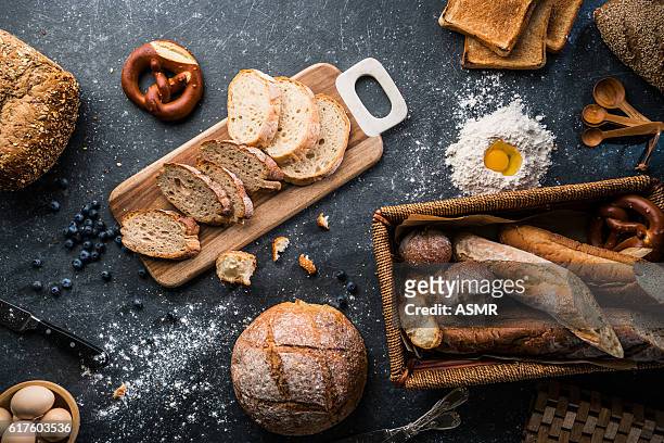 freshly baked bread on wooden table - food groups stockfoto's en -beelden
