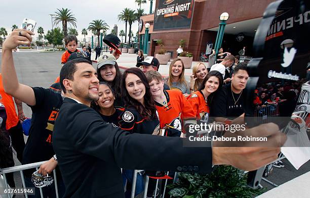 Emerson Etem of the Anaheim Ducks takes a selfie with fans prior to the game against the Vancouver Canucks on October 23, 2016 at Honda Center in...