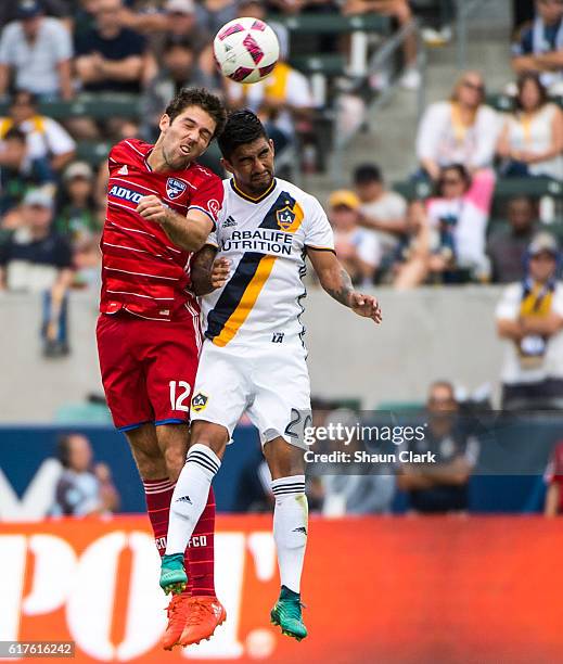 DeLaGarza of Los Angeles Galaxy challenges Ryan Hollingshead of FC Dallas during Los Angeles Galaxy's MLS match against FC Dallas at the StubHub...