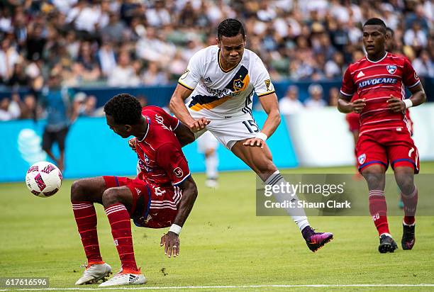 Ariel Lassiter of Los Angeles Galaxy runs into Atiba Harris of FC Dallas during Los Angeles Galaxy's MLS match against FC Dallas at the StubHub...