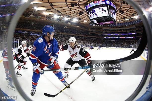 Ryan White of the Arizona Coyotes skates against J.T. Miller of the New York Rangers at Madison Square Garden on October 23, 2016 in New York City.