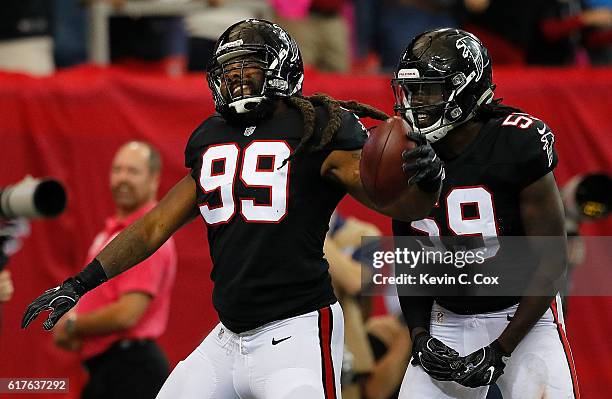 Adrian Clayborn of the Atlanta Falcons reacts after scooping up a fumble on the way to scoring a touchdown against he San Diego Chargers at Georgia...