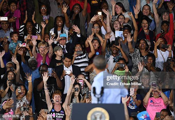 President Barack Obama turns around to see the crowd behind him as he speaks during a campaign rally for Democratic presidential nominee Hillary...