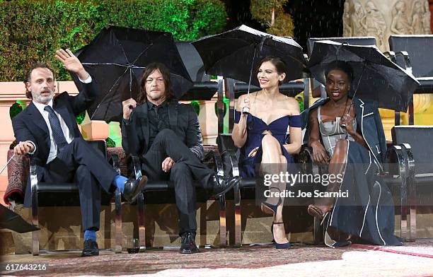 Actors Andrew Lincoln, Norman Reedus, Lauren Cohan and Danai Gurira speak onstage during AMC presents "Talking Dead Live" for the premiere of "The...