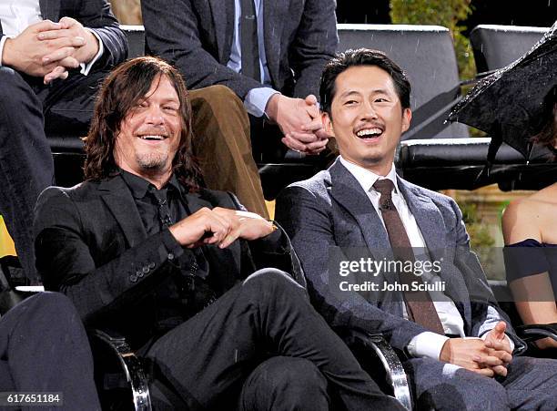 Actors Norman Reedus and Steven Yeun speak onstage during AMC presents "Talking Dead Live" for the premiere of "The Walking Dead" at Hollywood...