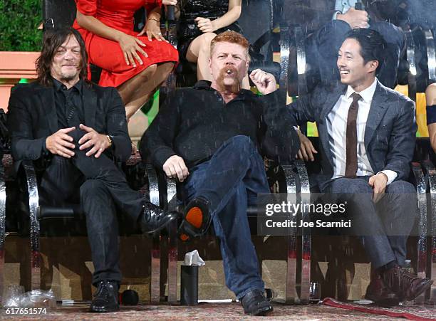 Actors Norman Reedus, Michael Cudlitz and Steven Yeun speak onstage during AMC presents "Talking Dead Live" for the premiere of "The Walking Dead" at...