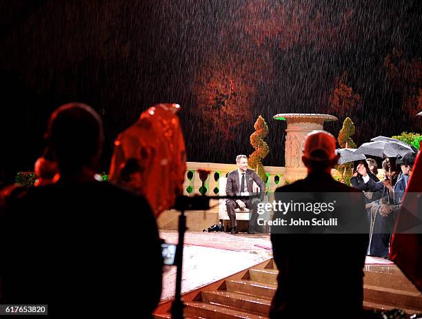 Host Chris Hardwick speaks onstage in the rain during AMC presents "Talking Dead Live" for the premiere of "The Walking Dead" at Hollywood Forever on...