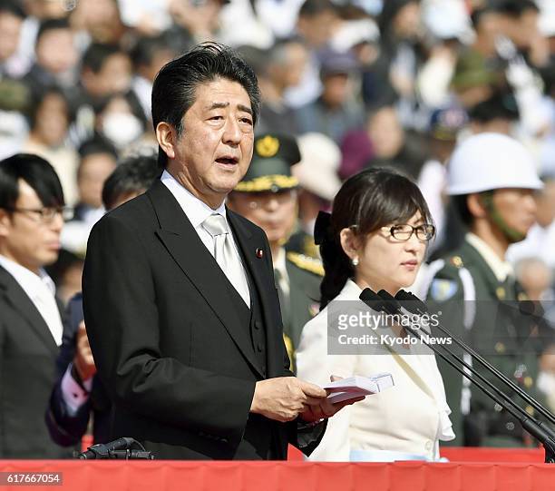 Japanese Prime Minister Shinzo Abe addresses an annual troop review of Japan's Self-Defense Forces at the Asaka garrison of the Ground Self-Defense...