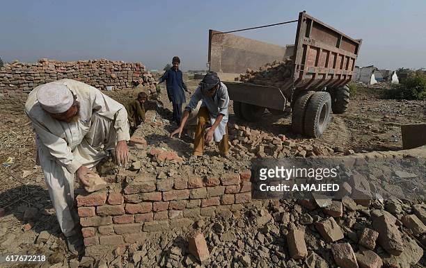 An Afghan refugee family demolish their house before return their home land under the UNHCR voluntary programme in khazana refugees camp outskirts of...