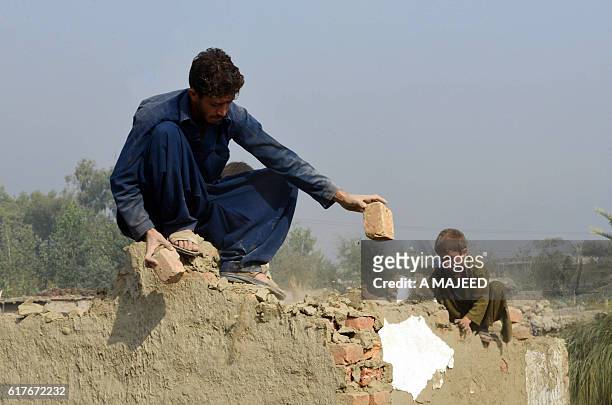 An Afghan refugee family demolishes their house before return their home land under the UNHCR voluntary programme in khazana refugees camp outskirts...