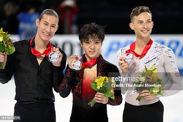 Silver nedakust Jason Brown of the United States, gold medalist Shoma Uno of Japan and bronze medalist Adam Rippon of the United States pose on the...