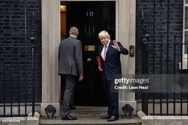 Britain's Foreign Secretary Boris Johnson waves as he enters during a meeting between British Prime Minister Theresa May and the leaders of the three...