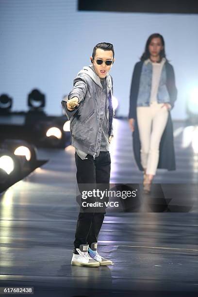 Singer Khalil Fong performs during Tmall global fashion event at Oriental Sports Center on October 23, 2016 in Shanghai, China.