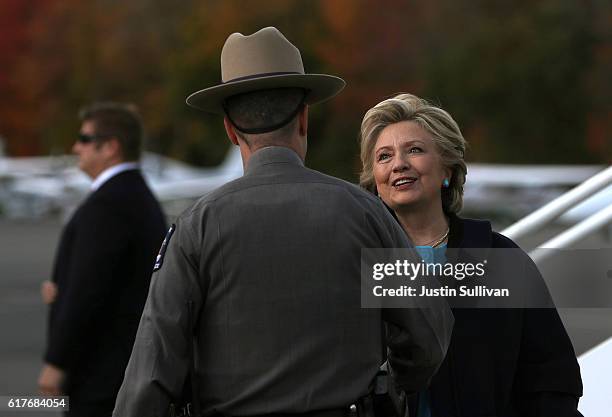 Democratic presidential nominee former Secretary of State Hillary Clinton greets local law enforcement before boarding her campaign plane at...