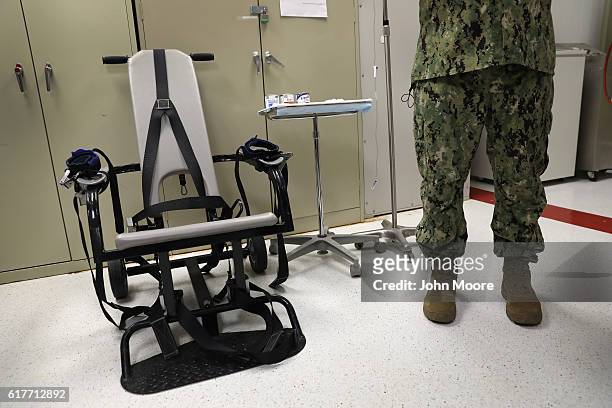 Navy doctor displays a restraint chair in the detainee clinic in the "Gitmo" maximum security detention center on October 22, 2016 at the U.S. Naval...