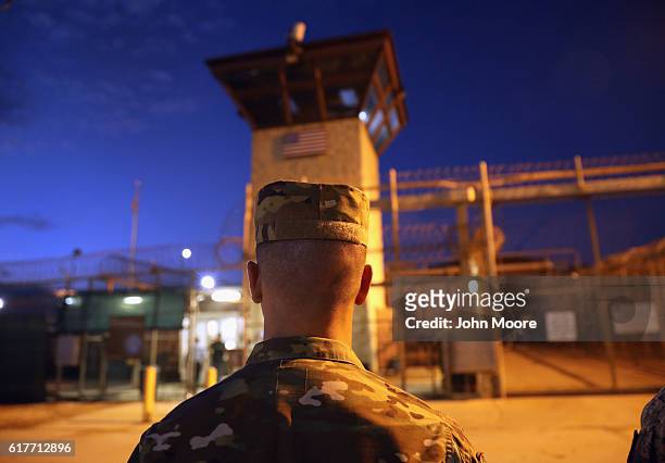 Army soldier stands outside the entrance of the "Gitmo" detention center on October 22, 2016 at the U.S. Naval Station at Guantanamo Bay, Cuba. The...