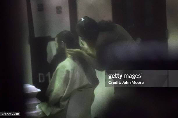 Prisoner helps another with his hair as they prepare for evening prayers at the "Gitmo" detention center on October 22, 2016 at the U.S. Naval...