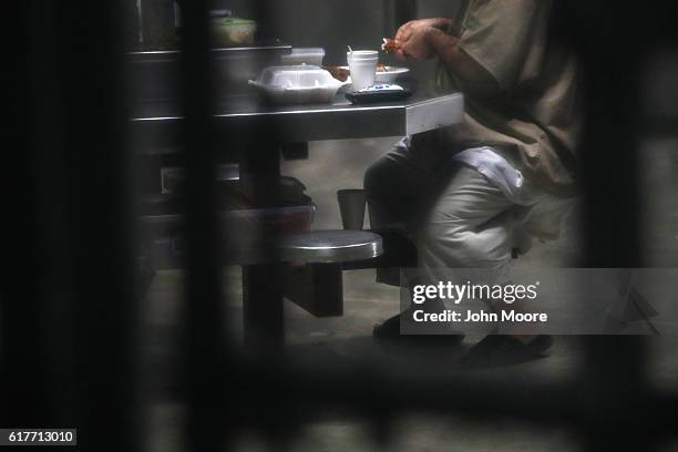 Prisoner prepares to eat lunch at the "Gitmo" maximum security detention center on October 22, 2016 at the U.S. Naval Station at Guantanamo Bay,...