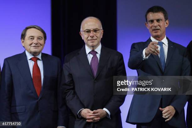 French politician and Member of the European Parliament Andre Laignel and France's Interior Minister Bernard Cazeneuve pose as France's Prime...