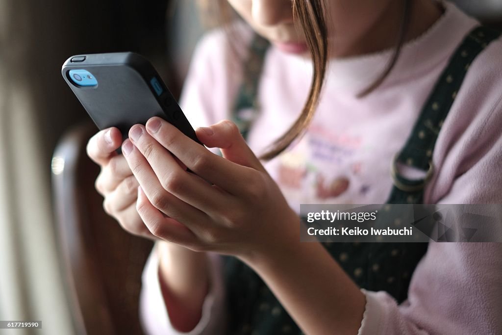 Kid looking at smartphone