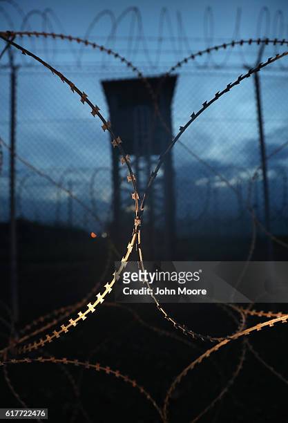 Razor wire and a guard tower stands at a closed section of the U.S. Prison at Guantanamo Bay, also known as "Gitmo" on October 22, 2016 at the U.S....