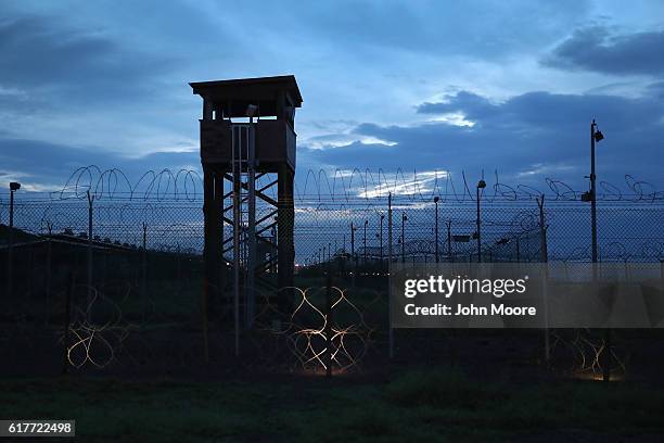 Razor wire and a guard tower stands at a closed section of the U.S. Prison at Guantanamo Bay, also known as "Gitmo" on October 22, 2016 at the U.S....