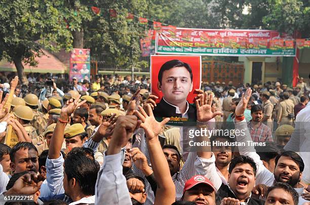 Supporters of Uttar Pradesh Chief Minister Akhilesh Yadav shout slogans outside party office during an internal Samajwadi Party meeting to resolve...