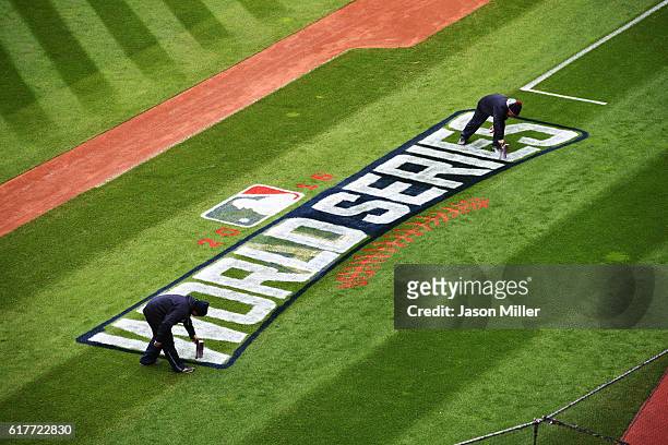 Members of the Cleveland Indians grounds crew paint the World Series logo on the field prior to Media Day at Progressive Field on October 24, 2016 in...