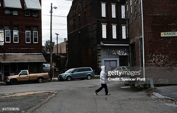 Person walks down a street in downtown on October 24, 2016 in East Liverpool, Ohio. East Liverpool, once prosperous from steel mills and a vibrant...