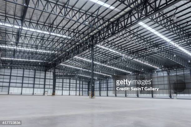 interior of empty warehouse - halle stock-fotos und bilder