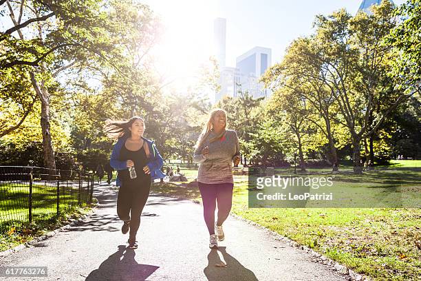 women jogging in central park new york - central park new york stock pictures, royalty-free photos & images