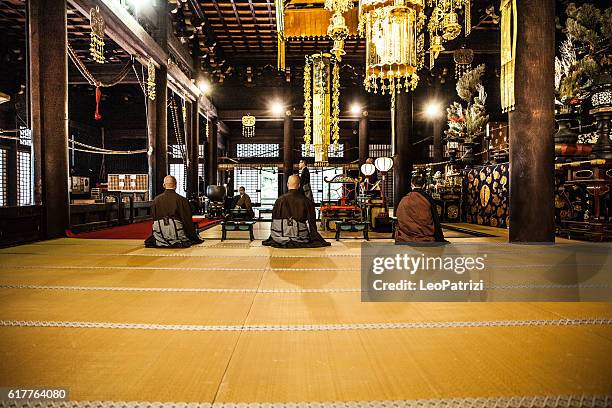 buddhist monks praying in early morning inside a temple - japan temple stock pictures, royalty-free photos & images