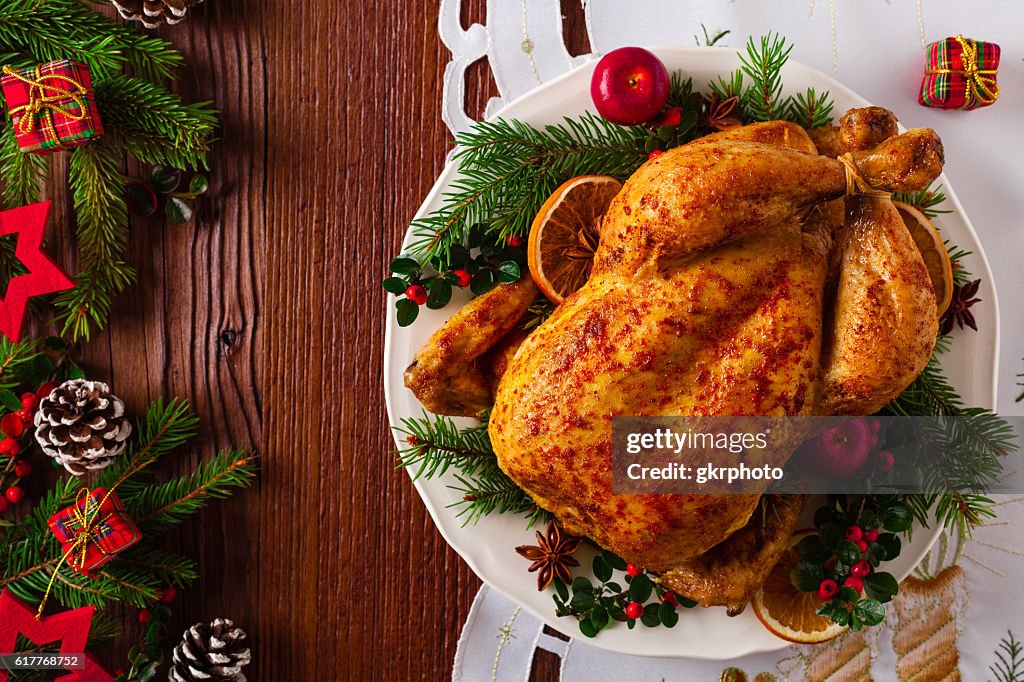 Roasted whole chicken with Christmas decoration.
