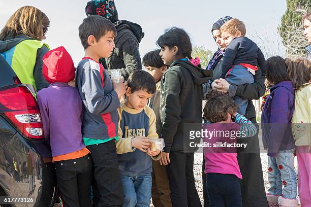 food line in greek refugee camp - refugee camp greece stock pictures, royalty-free photos & images