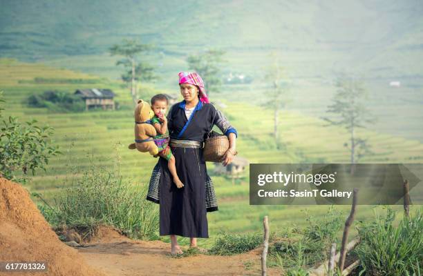 mother and daughter in rice terraces - tribal head gear in china stock pictures, royalty-free photos & images