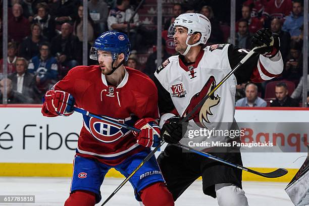 Paul Byron of the Montreal Canadiens and Jamie McBain of the Arizona Coyotes battle for position during the NHL game at the Bell Centre on October...