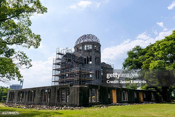the ruin of the hiroshima prefectural industrial promotion hall known as the atomic bomb dome or genbaku d&#333;mu. - hiroshima peace memorial park stock pictures, royalty-free photos & images