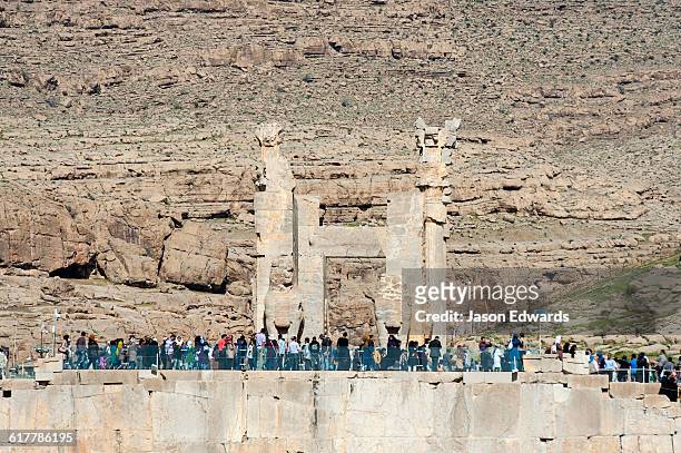 crowds of iranian tourists gather at the gate of all nations in persepolis. - iran persepolis stock pictures, royalty-free photos & images