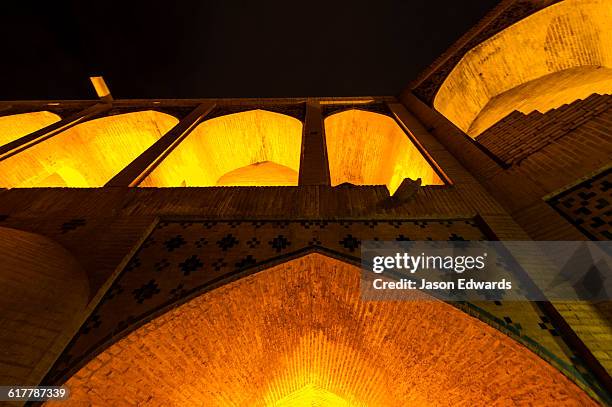 light cascades from iwans lining the khaju bridge at night during nowruz iranian new year. - persian new year nowruz stock pictures, royalty-free photos & images
