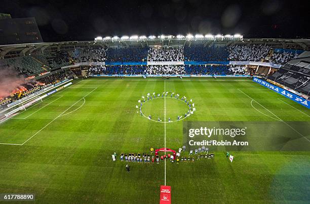 General view of Gamla Ullevi, players of AIK and IFK Goteborg stand in line and fans of AIK burning bengals and fans of IFK Goteborg hold up flags...