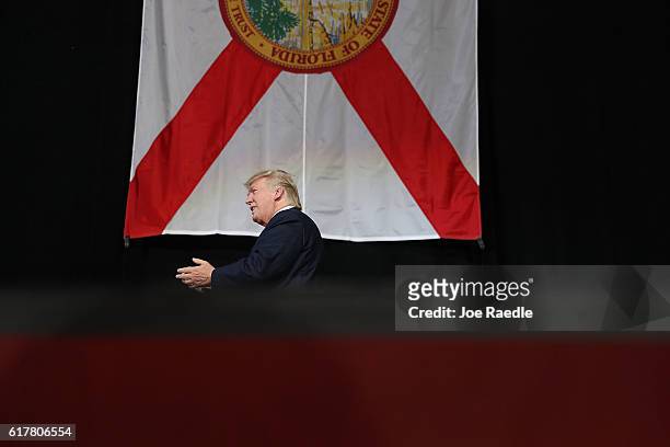 Republican presidential candidate Donald Trump arrives on stage to speak during a campaign rally at the MidFlorida Credit Union Amphitheatre on...