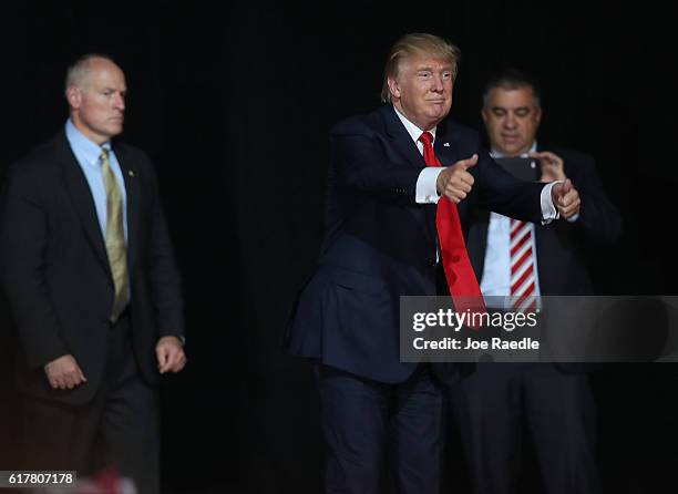 Republican presidential candidate Donald Trump gestures during a campaign rally at the MidFlorida Credit Union Amphitheatre on October 24, 2016 in...