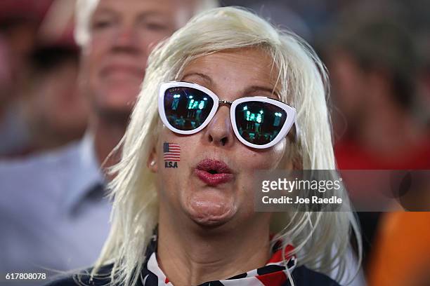 People wait for the arrival of Republican presidential candidate Donald Trump for his campaign rally at the MidFlorida Credit Union Amphitheatre on...
